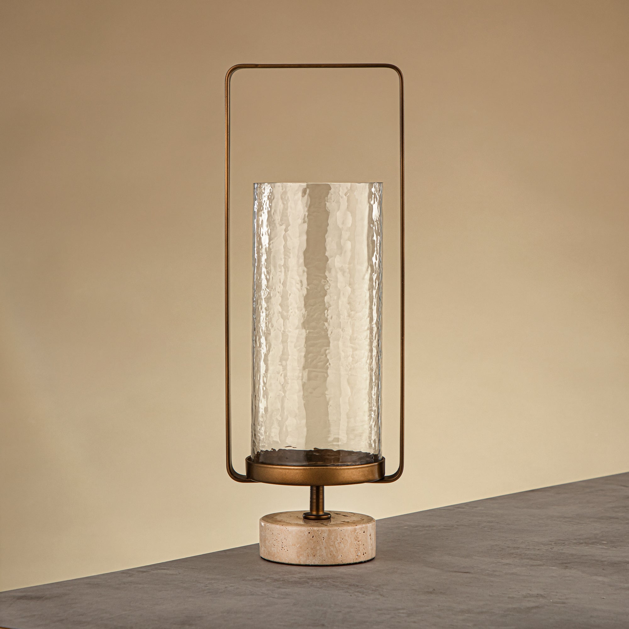 Almarjan Kalon Hurricane Lantern Hammered Clear Glass 16x10.5x43.5 CM Brushed Gold & Travertine Base (GMT2960029)
